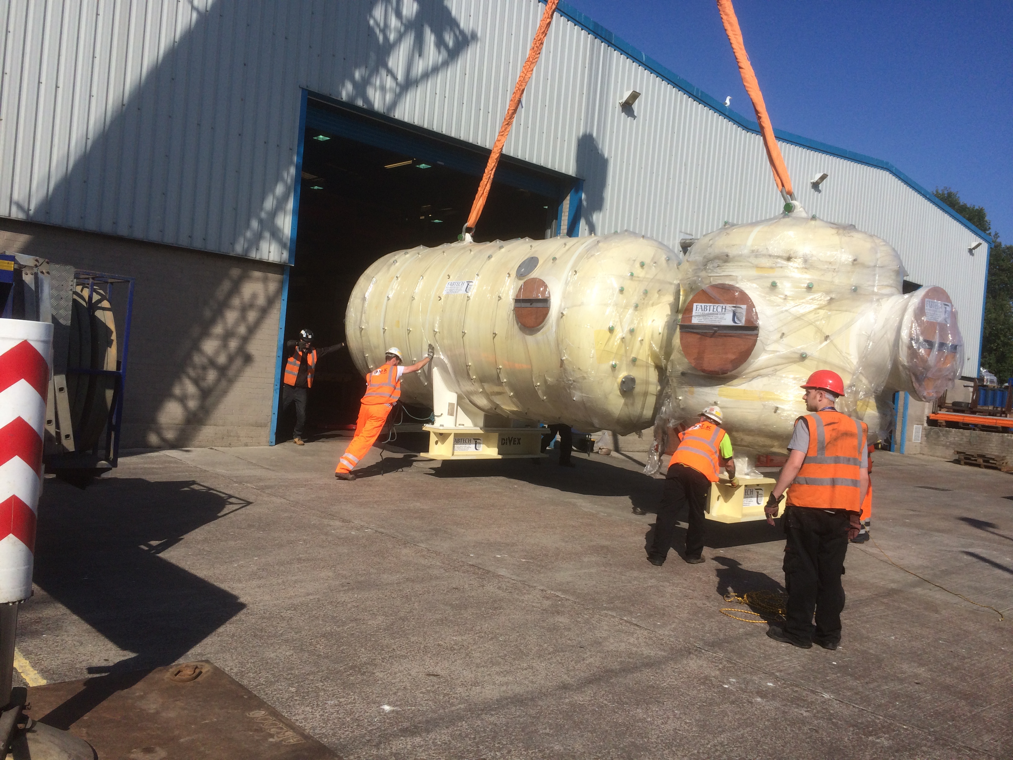 MK Site Services crew moving a large industrial vessel into storage